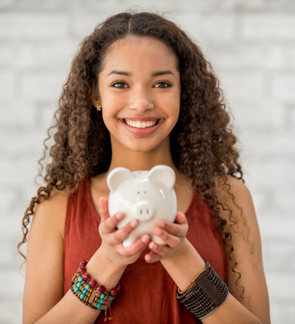 Teenager holding a piggy bank for the Lights, Camera, Save page.