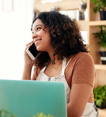 Woman in apron talking on phone