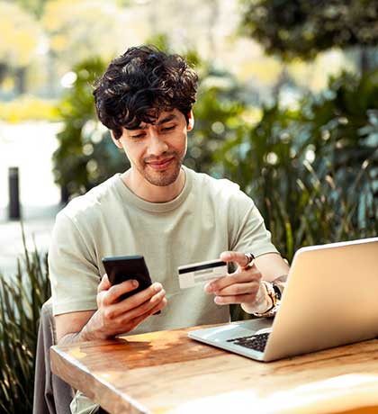 Man holding card and phone